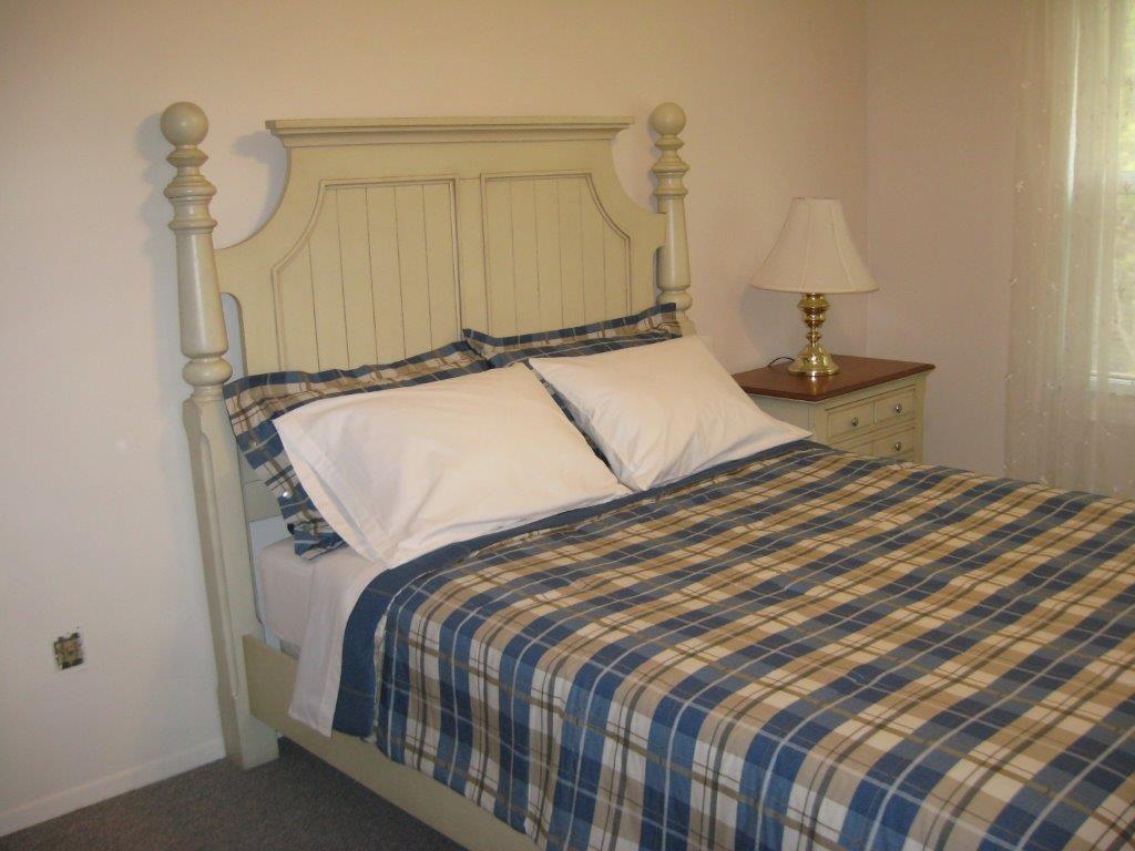 Queen bed in a two-bedroom apartment (unit 210)